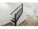 Staircase featuring black iron railing at 1425 N Grant Ave, Indianapolis, IN 46201