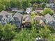 Aerial view of a neighborhood showcasing a well-maintained blue home surrounded by lush greenery and neighboring properties at 1436 Central Ave, Indianapolis, IN 46202