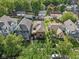 Aerial view of a neighborhood showcasing a well-maintained blue home surrounded by lush greenery and neighboring properties at 1436 Central Ave, Indianapolis, IN 46202