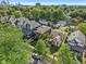 Aerial view of a neighborhood showcasing a well-maintained blue home surrounded by lush greenery and a cityscape in the background at 1436 Central Ave, Indianapolis, IN 46202
