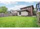 Backyard view with grass, privacy fence, and sunroom attached to home at 1436 Central Ave, Indianapolis, IN 46202