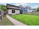 Backyard view showing grassy yard, wooden fence, and sunroom attached to house at 1436 Central Ave, Indianapolis, IN 46202