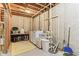 Unfinished basement utility area with washer, dryer and storage with exposed ceiling at 1436 Central Ave, Indianapolis, IN 46202