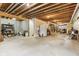 Unfinished basement provides ample storage space with exposed ceiling beams and concrete floor at 1436 Central Ave, Indianapolis, IN 46202