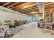 Unfinished basement provides ample storage space, with exposed beams and concrete floor at 1436 Central Ave, Indianapolis, IN 46202