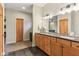 Bathroom featuring double vanity with modern lighting and a view to the bedroom at 1436 Central Ave, Indianapolis, IN 46202