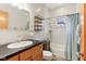 Bright bathroom featuring classic fixtures, tub/shower, and a wood door at 1436 Central Ave, Indianapolis, IN 46202