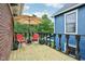 Charming deck with red chairs and table offering a great outdoor space to relax with friends and Gathering at 1436 Central Ave, Indianapolis, IN 46202