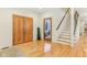 Welcoming entryway features hardwood floors, a staircase, and a closet for coats and storage at 1436 Central Ave, Indianapolis, IN 46202