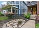 Beautifully landscaped front yard with a stone walkway, swing, and lush greenery enhances the home's curb appeal at 1436 Central Ave, Indianapolis, IN 46202