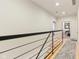 Hallway with metal railing and hardwood floors leading to bedrooms at 1436 Central Ave, Indianapolis, IN 46202