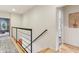 Hallway with metal railing and hardwood floors leading to other rooms at 1436 Central Ave, Indianapolis, IN 46202