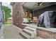 Covered porch offers a cozy outdoor space with seating and an outdoor grill at 1436 Central Ave, Indianapolis, IN 46202