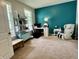 Bedroom with a teal accent wall, chair massage, white shelving, and light-filled windows at 1518 Valdarno Dr, Greenwood, IN 46143