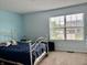Cozy bedroom with large window offering lots of natural light and plush carpet at 1518 Valdarno Dr, Greenwood, IN 46143