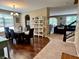 Spacious dining area with hardwood floors leading to a cozy living room and staircase at 1518 Valdarno Dr, Greenwood, IN 46143