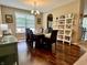 Formal dining room with hardwood floors, large table, and modern lighting fixture, ideal for gatherings at 1518 Valdarno Dr, Greenwood, IN 46143
