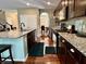 Well-lit kitchen featuring dark cabinets, granite countertops, hardwood floors, and stainless steel appliances at 1518 Valdarno Dr, Greenwood, IN 46143