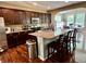 Modern kitchen with dark wood cabinets, granite countertops, and a center island with barstools at 1518 Valdarno Dr, Greenwood, IN 46143