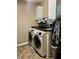 Functional laundry room featuring white cabinets and modern washer and dryer at 1518 Valdarno Dr, Greenwood, IN 46143