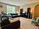 Spacious living room with a large sectional sofa, TV, and a cozy armchair for relaxation at 1518 Valdarno Dr, Greenwood, IN 46143