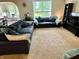 Comfortable living room featuring a large sectional sofa, entertainment center, and plenty of natural light at 1518 Valdarno Dr, Greenwood, IN 46143