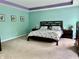 Tranquil main bedroom features a floral-patterned bed, soft carpet, and calming light-green walls at 1518 Valdarno Dr, Greenwood, IN 46143