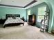 Bright main bedroom with a cozy bed, soft carpet, ample natural light, and a unique cat tree at 1518 Valdarno Dr, Greenwood, IN 46143