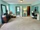 Expansive main bedroom features a dresser, carpet, and access to a walk-in closet and sitting area at 1518 Valdarno Dr, Greenwood, IN 46143