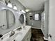 Bright bathroom featuring a dual sink vanity, modern fixtures, and a shower at 1579 Crest Dr, Shelbyville, IN 46176