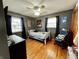 Bedroom with two windows, wood floors, ceiling fan, and furniture at 1579 Crest Dr, Shelbyville, IN 46176