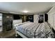 Spacious bedroom featuring a queen bed, wood accent wall, and barn door closet at 1579 Crest Dr, Shelbyville, IN 46176