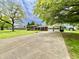 View of home and long driveway with a basketball hoop on a well maintained lawn at 1579 Crest Dr, Shelbyville, IN 46176