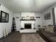 Cozy living room featuring a white brick fireplace with decorative mantel and plush furnishings at 1579 Crest Dr, Shelbyville, IN 46176