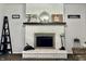 Close-up of brick fireplace features charming decor and a neutral hearth, creating a focal point at 1579 Crest Dr, Shelbyville, IN 46176