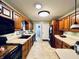 Bright kitchen featuring wooden cabinets, tile flooring and modern appliances and countertops at 1579 Crest Dr, Shelbyville, IN 46176
