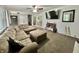 Spacious living room with a gray accent wall, cozy sectional, and staircase in background at 1579 Crest Dr, Shelbyville, IN 46176