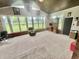 Sunroom with many windows, vaulted wood ceiling, furniture and carpet at 1579 Crest Dr, Shelbyville, IN 46176