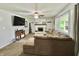 Comfortable living room features a brick fireplace, neutral carpet and a large sectional sofa at 1579 Crest Dr, Shelbyville, IN 46176