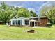 Brick home with a large sunroom addition and manicured lawn at 1579 Crest Dr, Shelbyville, IN 46176