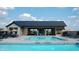 Beautiful community pool with ample seating, umbrellas, and a modern pool house at 1675 Solebar Way, Westfield, IN 46074