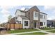 This exterior home view showcases manicured landscaping with a wood privacy fence, a stone walkway, and mixed material facade at 1675 Solebar Way, Westfield, IN 46074