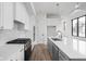 Gourmet kitchen features white cabinets, gray island, stainless steel appliances, and quartz countertops at 1675 Solebar Way, Westfield, IN 46074