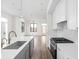 This modern kitchen provides an open concept view with a kitchen island, white cabinets, and stainless steel appliances at 1675 Solebar Way, Westfield, IN 46074
