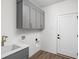Bright laundry room with gray cabinets, sink and white trim at 1675 Solebar Way, Westfield, IN 46074