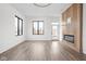 This bright living room includes hardwood floors, large windows, and a modern fireplace at 1675 Solebar Way, Westfield, IN 46074