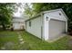 Backyard exterior features a small deck and detached garage for extra storage at 2012 George St, Anderson, IN 46016
