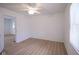 Bright bedroom features a ceiling fan, neutral paint, and durable laminate flooring at 2012 George St, Anderson, IN 46016