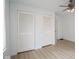 Bedroom features a large closet, neutral paint, laminate flooring, and overhead lighting at 2012 George St, Anderson, IN 46016