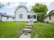 Exterior front elevation features a well manicured yard and quaint curb appeal at 2012 George St, Anderson, IN 46016
